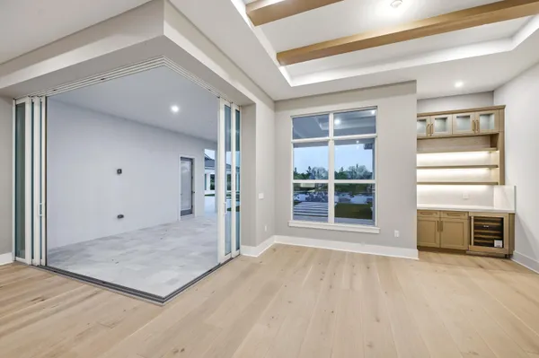 a large kitchen with stainless steel appliances kitchen island a large counter top and a refrigerator