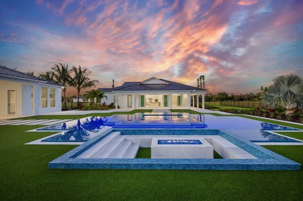 a front view of house with yard swimming pool and outdoor seating