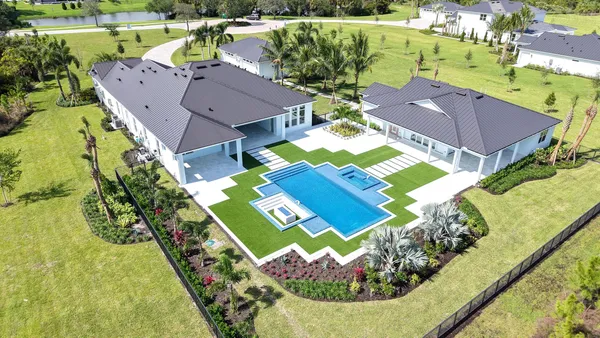 an aerial view of a house with a swimming pool
