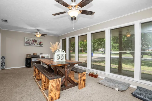 a view of a livingroom with furniture window and a ceiling fan