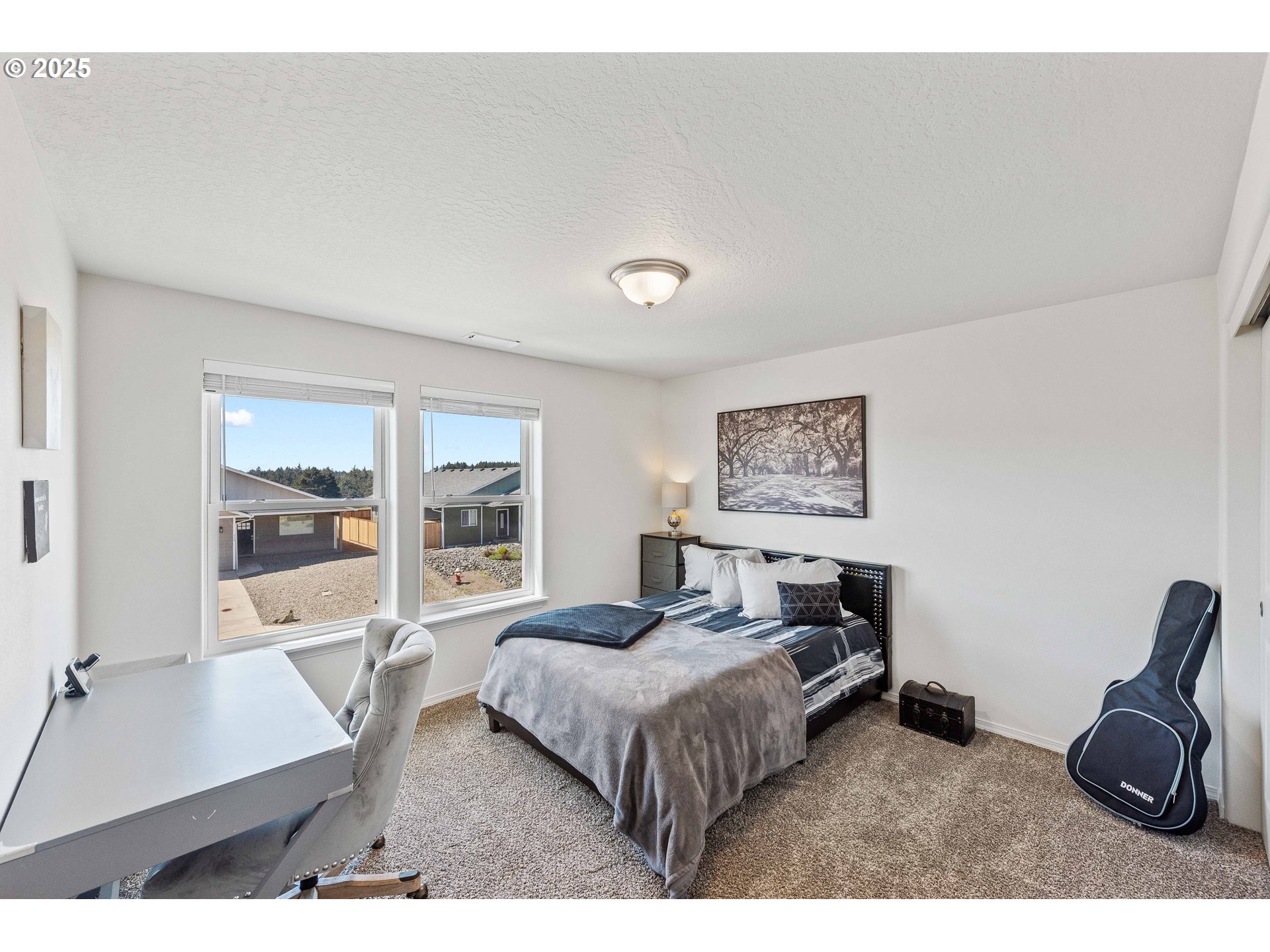764 Seacrest Drive Bandon, OR 97411 - Photo 17 of 43 a living room with furniture a large window and gym equipment