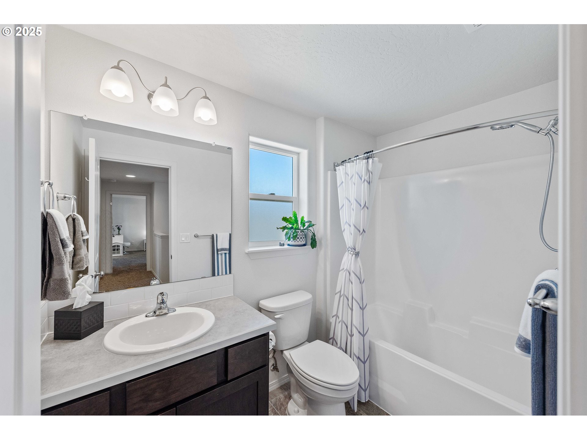 764 Seacrest Drive Bandon, OR 97411 - Photo 20 of 43 a bathroom with a sink toilet a mirror and shower