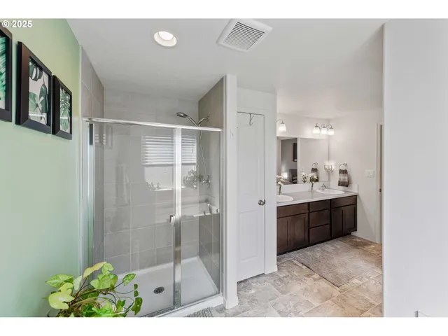 a bathroom with a granite countertop sink mirror and shower