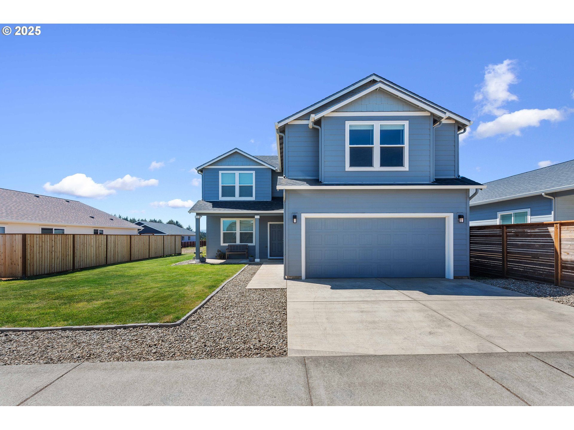 764 Seacrest Drive Bandon, OR 97411 - Photo 39 of 43 a front view of a house with a yard and garage