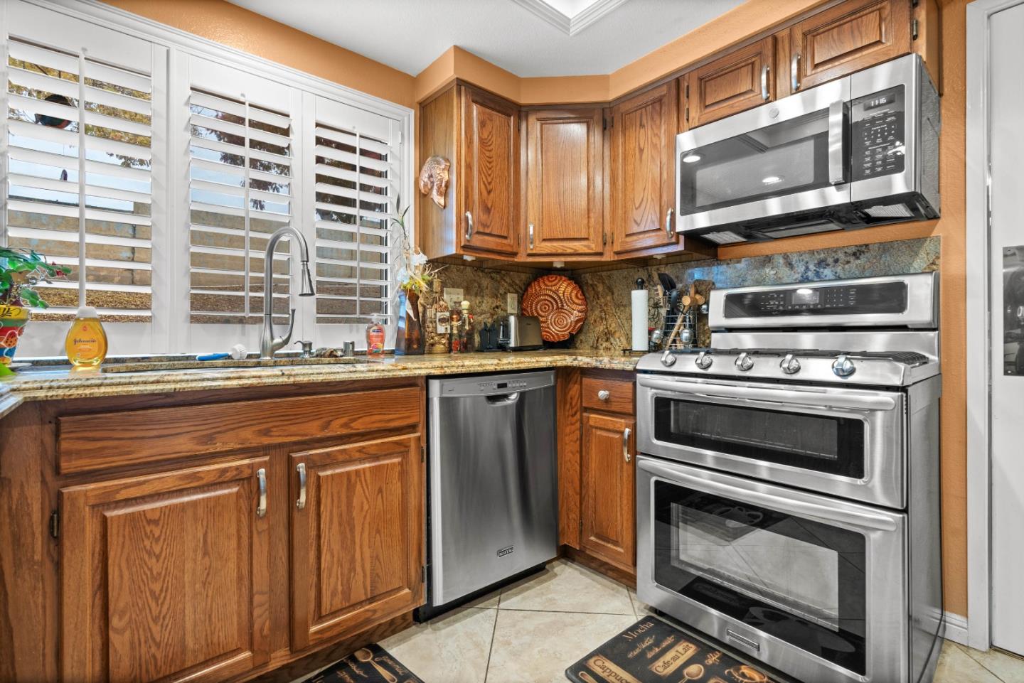 3040 Cedar Ridge Court San Jose, CA 95148 - Photo 18 of 40 a kitchen with stainless steel appliances granite countertop a stove and a microwave