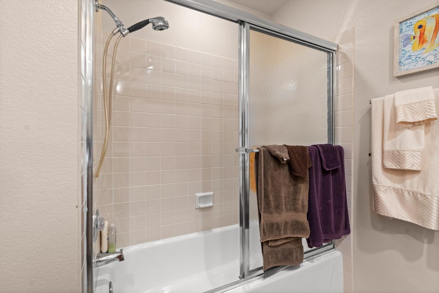 3040 Cedar Ridge Court San Jose, CA 95148 - Photo 28 of 40 a bathroom with a shower and a glass door