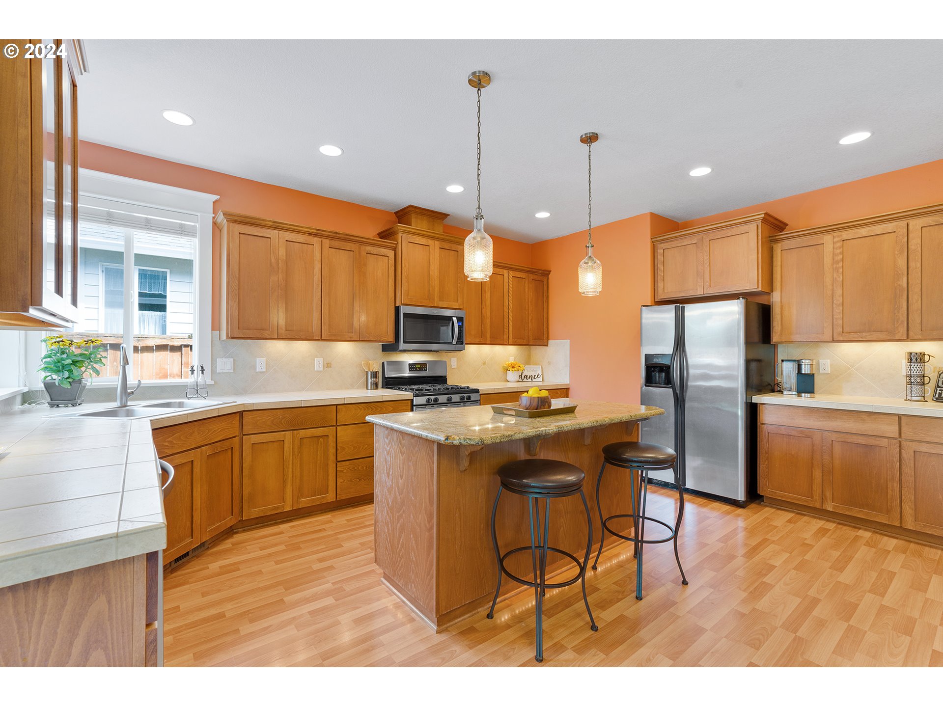18445 Brookside Road Oregon City, OR 97045 - Photo 18 of 46 a kitchen with stainless steel appliances kitchen island granite countertop a sink refrigerator and cabinets