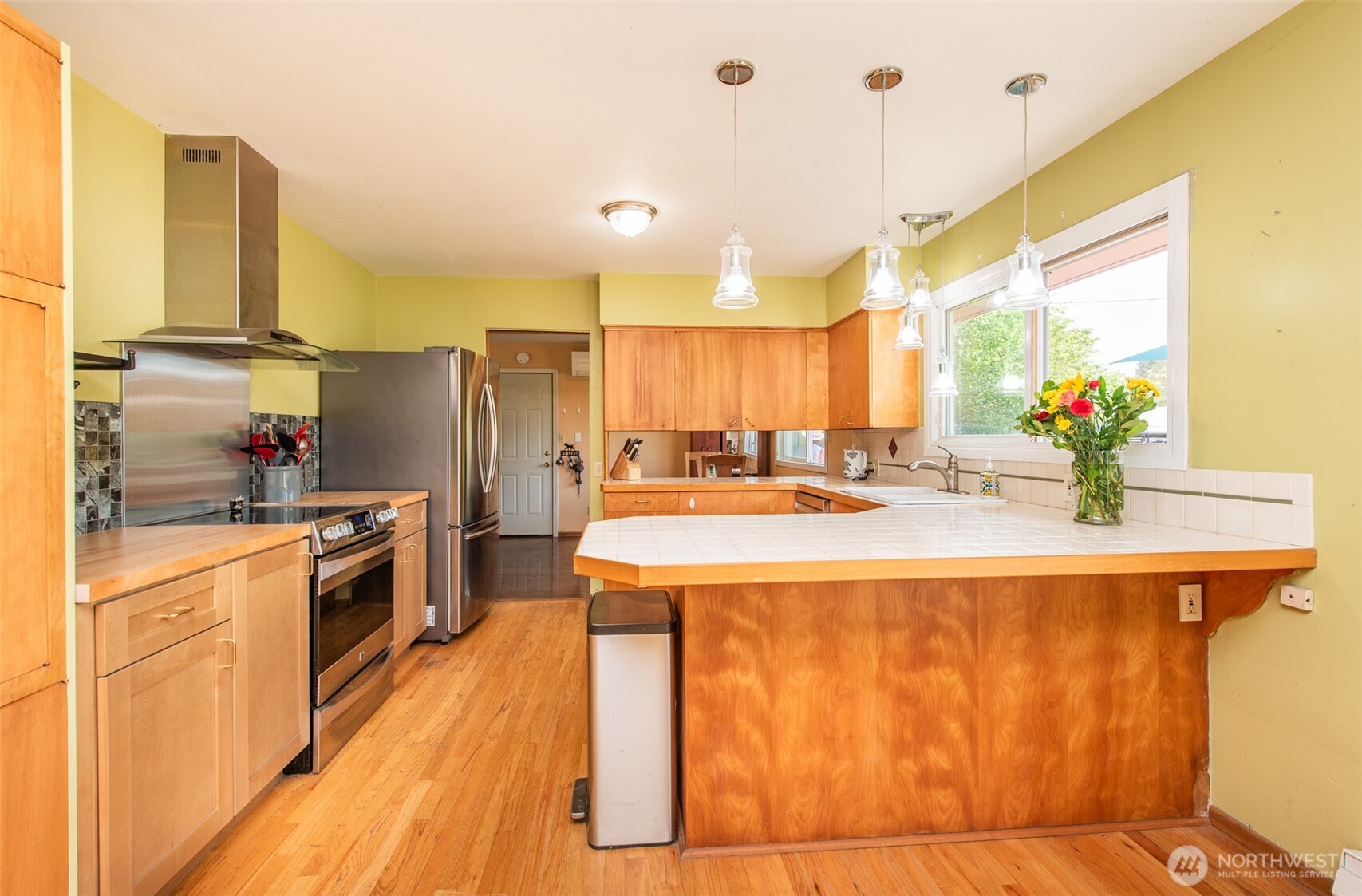 307 East Fir Street Sequim, WA 98382 - Photo 11 of 29 a kitchen with stainless steel appliances kitchen island granite countertop a sink a stove and a refrigerator