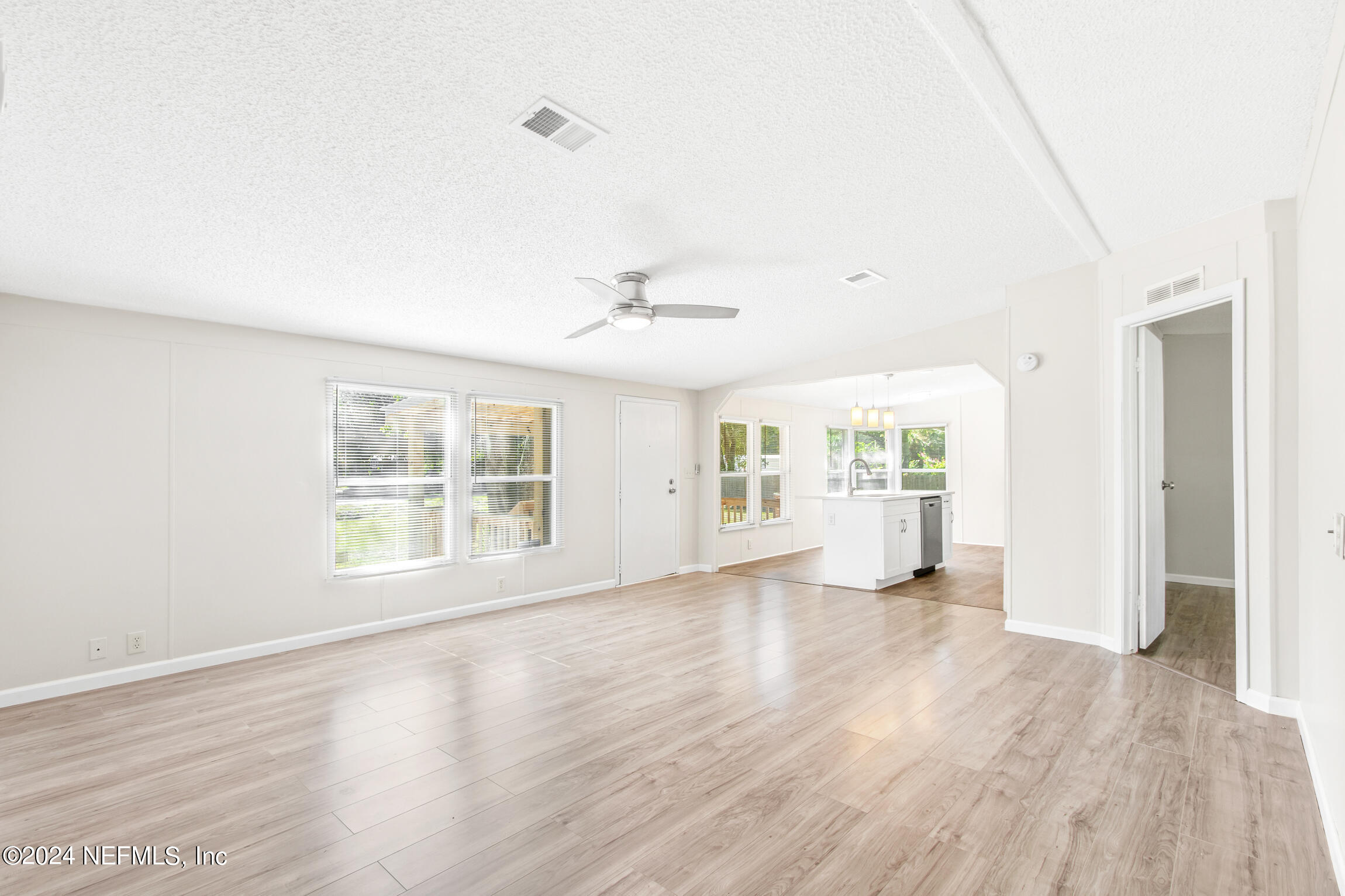 1650 Natalie Road St. Augustine, FL 32084 - Photo 11 of 44 an empty room with wooden floor and windows