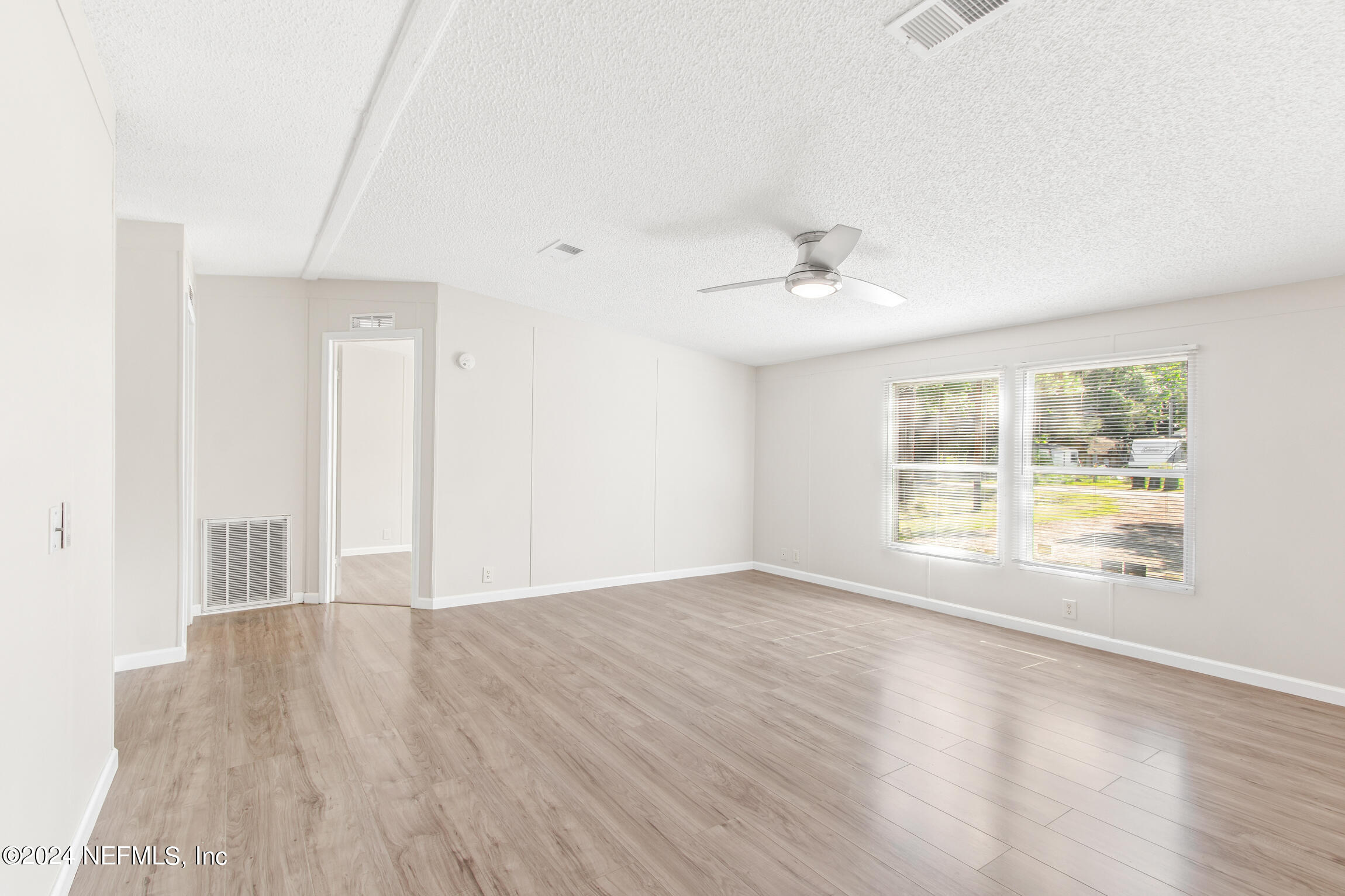1650 Natalie Road St. Augustine, FL 32084 - Photo 12 of 44 a view of an empty room with a window and wooden floor
