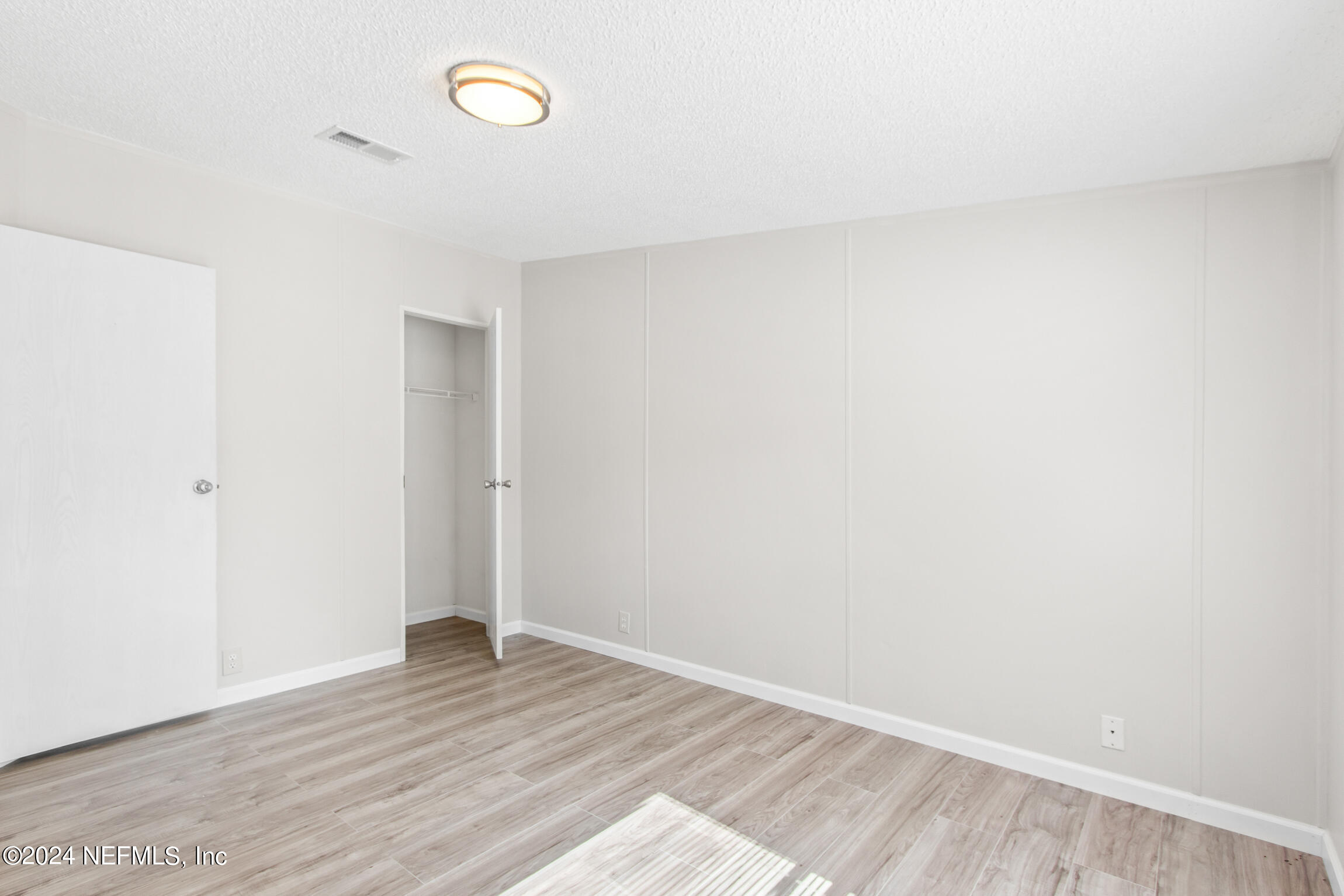 1650 Natalie Road St. Augustine, FL 32084 - Photo 19 of 44 a view of an empty room with wooden floor and a window