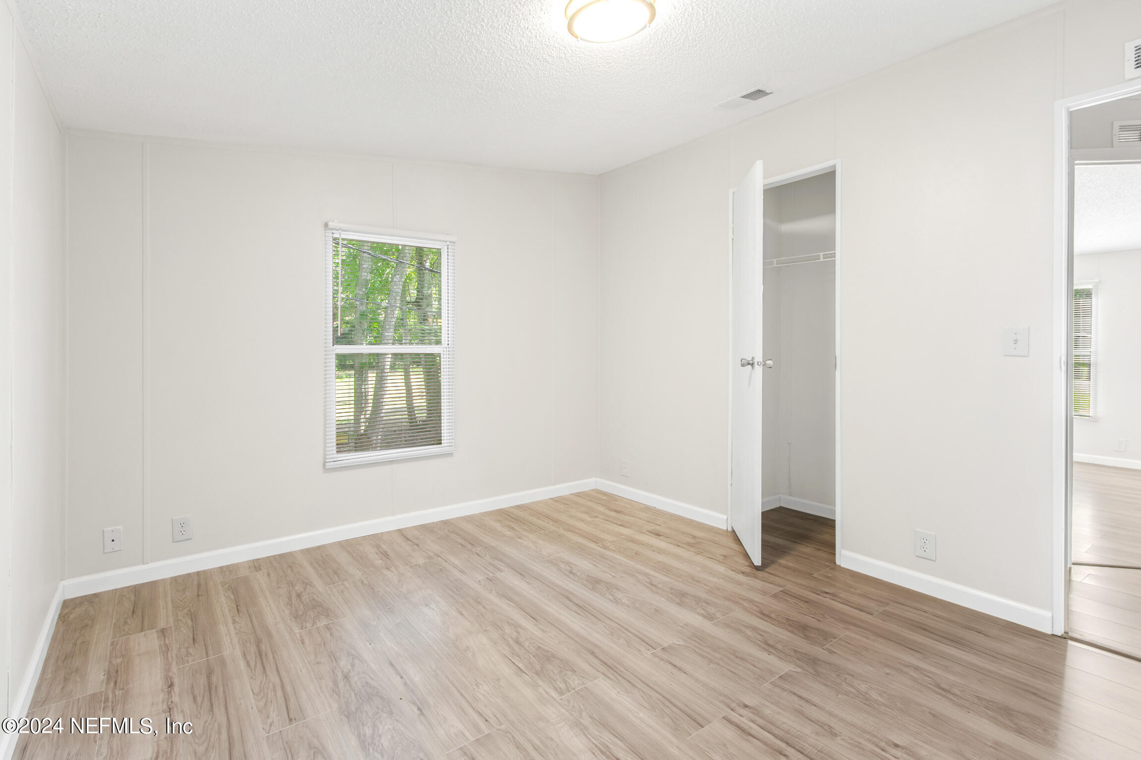 1650 Natalie Road St. Augustine, FL 32084 - Photo 20 of 44 an empty room with wooden floor and windows