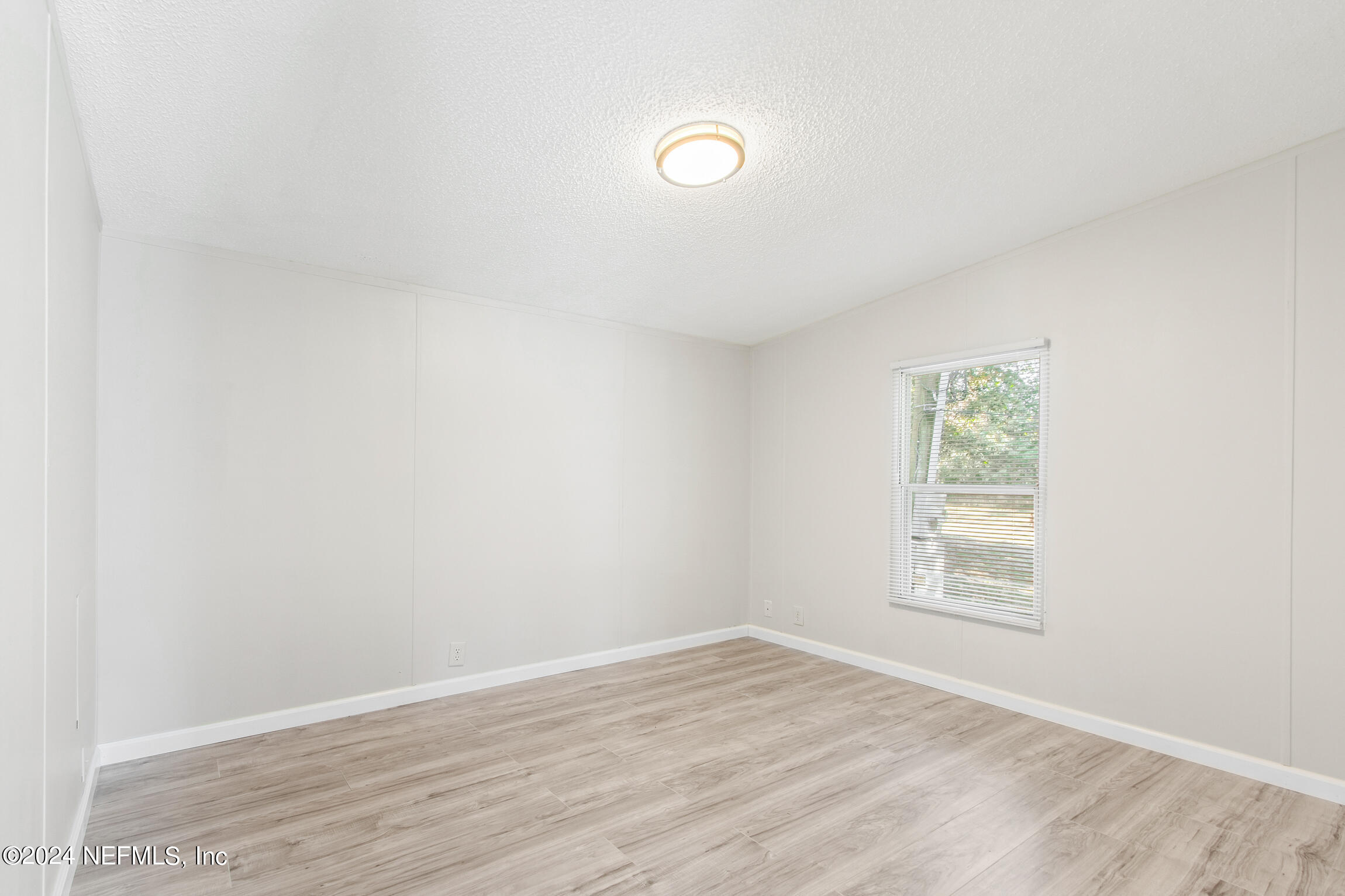1650 Natalie Road St. Augustine, FL 32084 - Photo 23 of 44 an empty room with wooden floor and windows