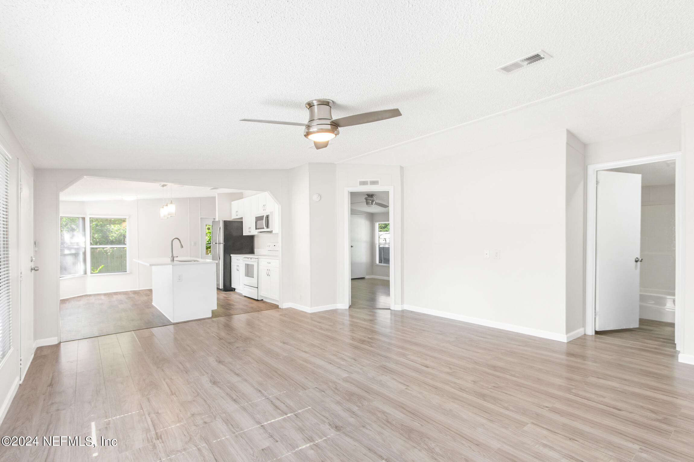 1650 Natalie Road St. Augustine, FL 32084 - Photo 9 of 44 a view of an empty room with wooden floor and a window