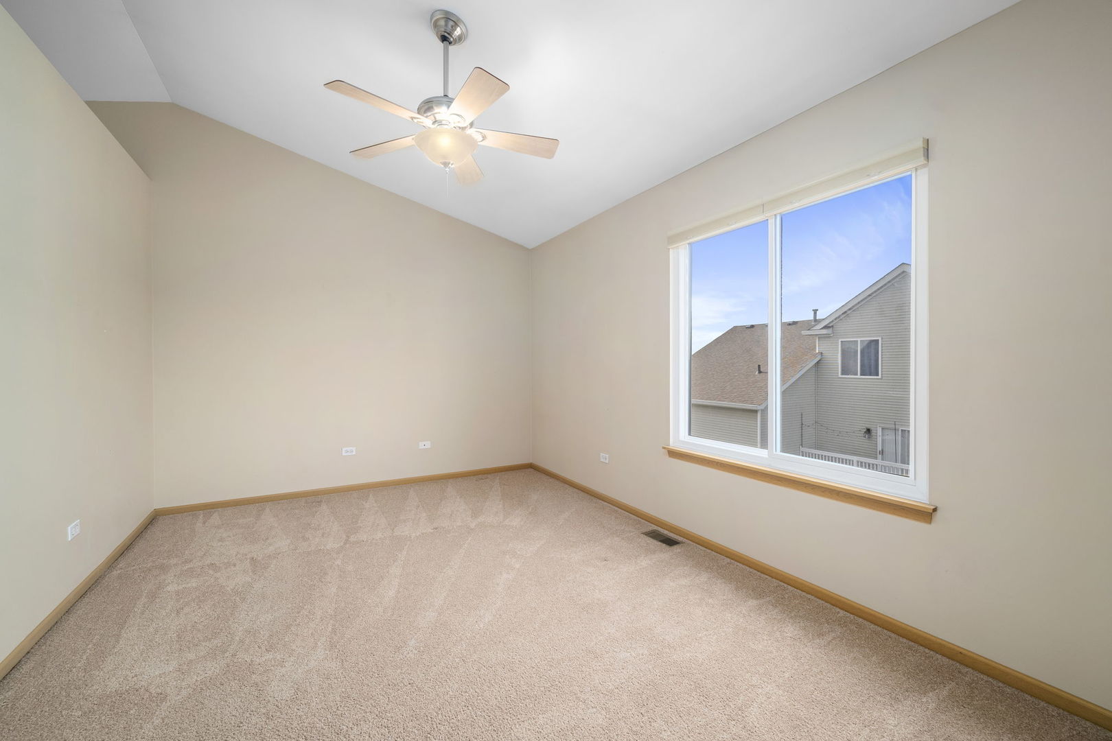 1784 Fieldstone Drive North Shorewood, IL 60404 - Photo 17 of 24 an empty room with windows and fan