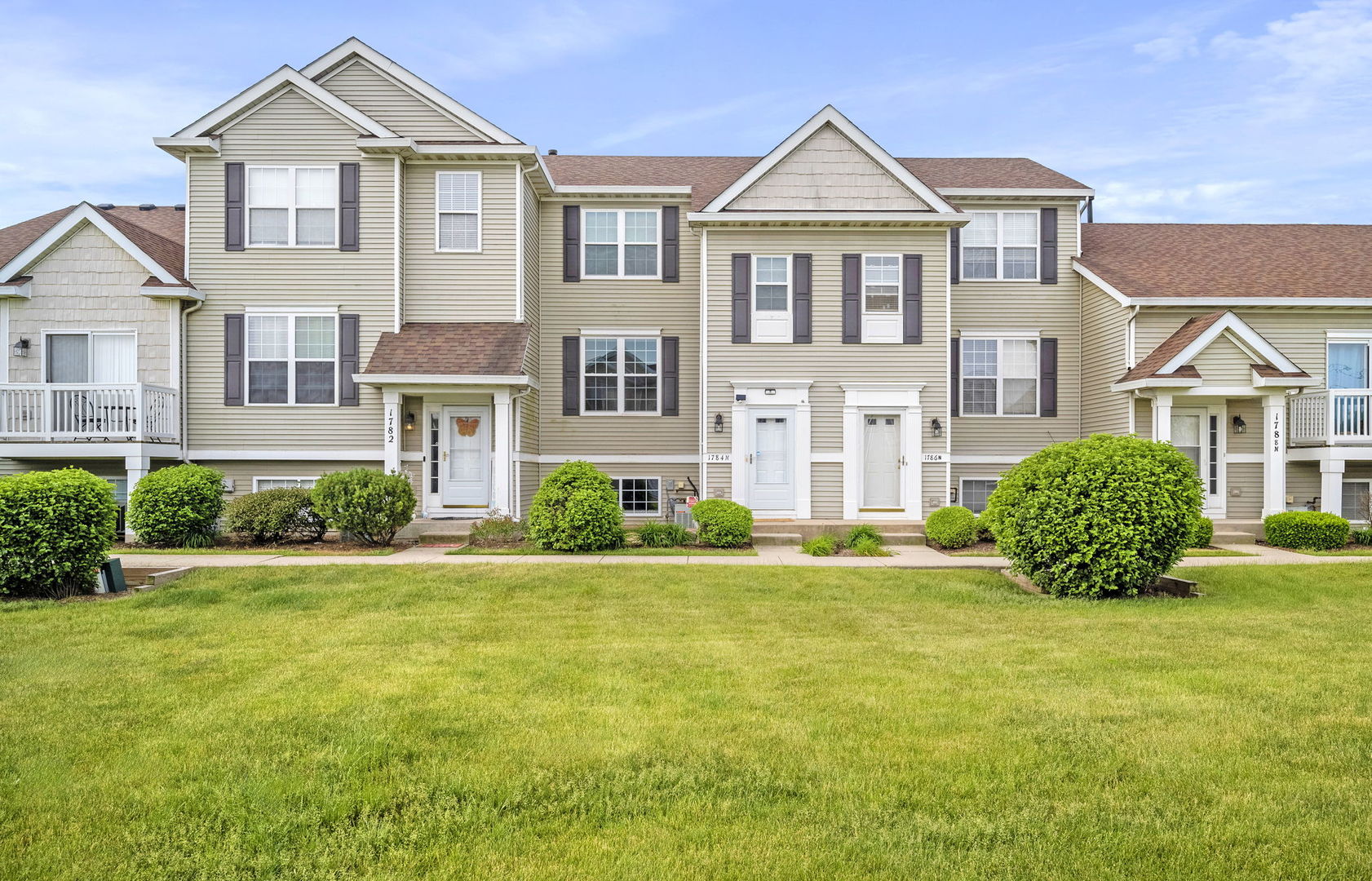 1784 Fieldstone Drive North Shorewood, IL 60404 - Photo 2 of 24 a front view of a house with a yard