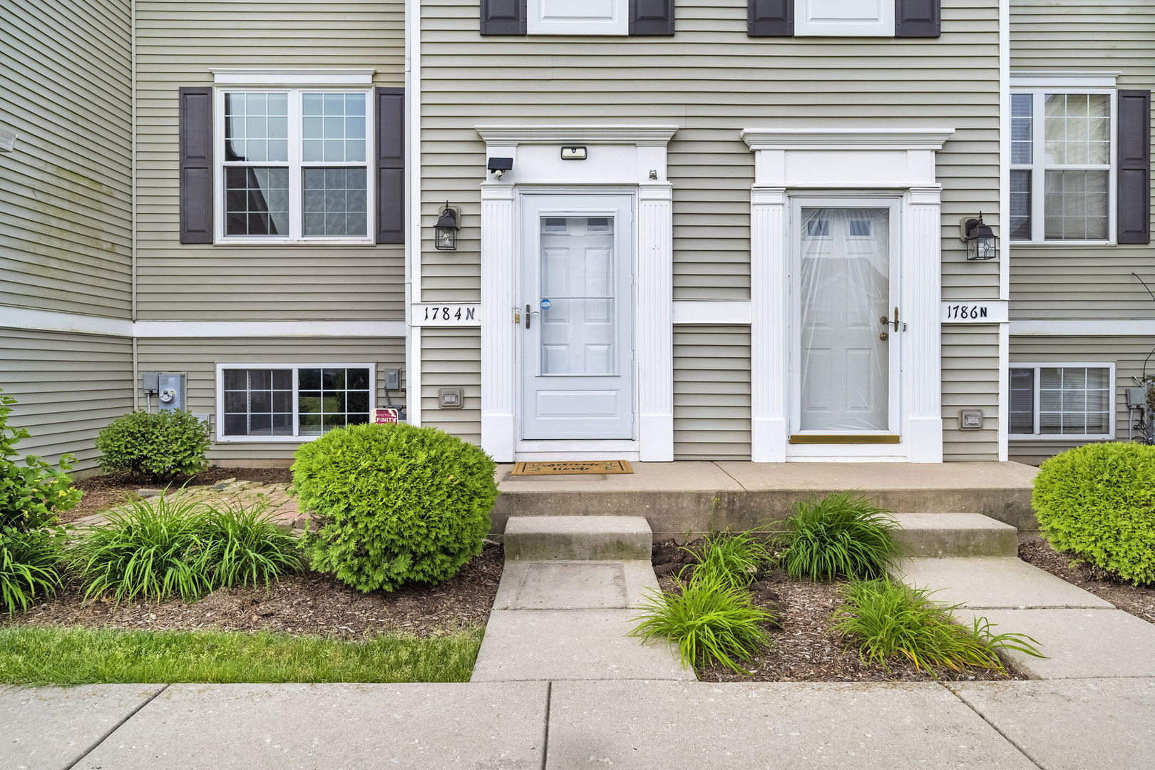 1784 Fieldstone Drive North Shorewood, IL 60404 - Photo 3 of 24 a front view of a house with garden