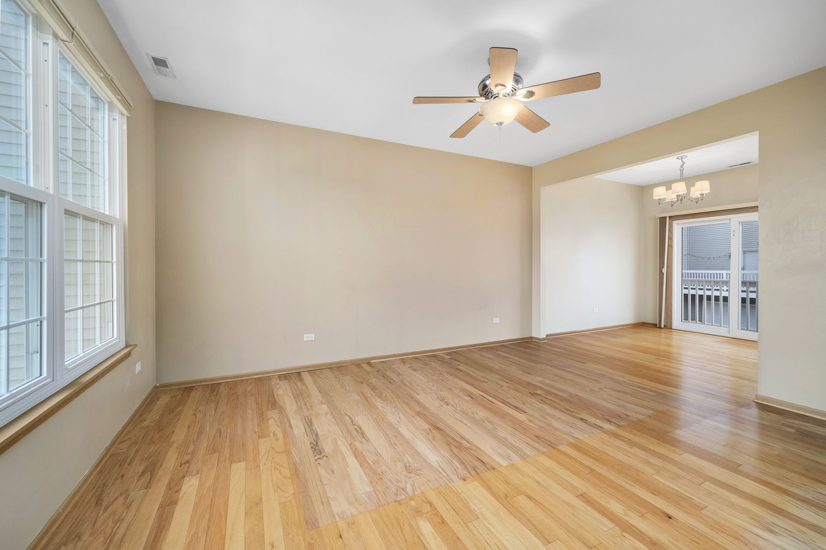 1784 Fieldstone Drive North Shorewood, IL 60404 - Photo 5 of 24 a view of a room with wooden floor and a ceiling fan
