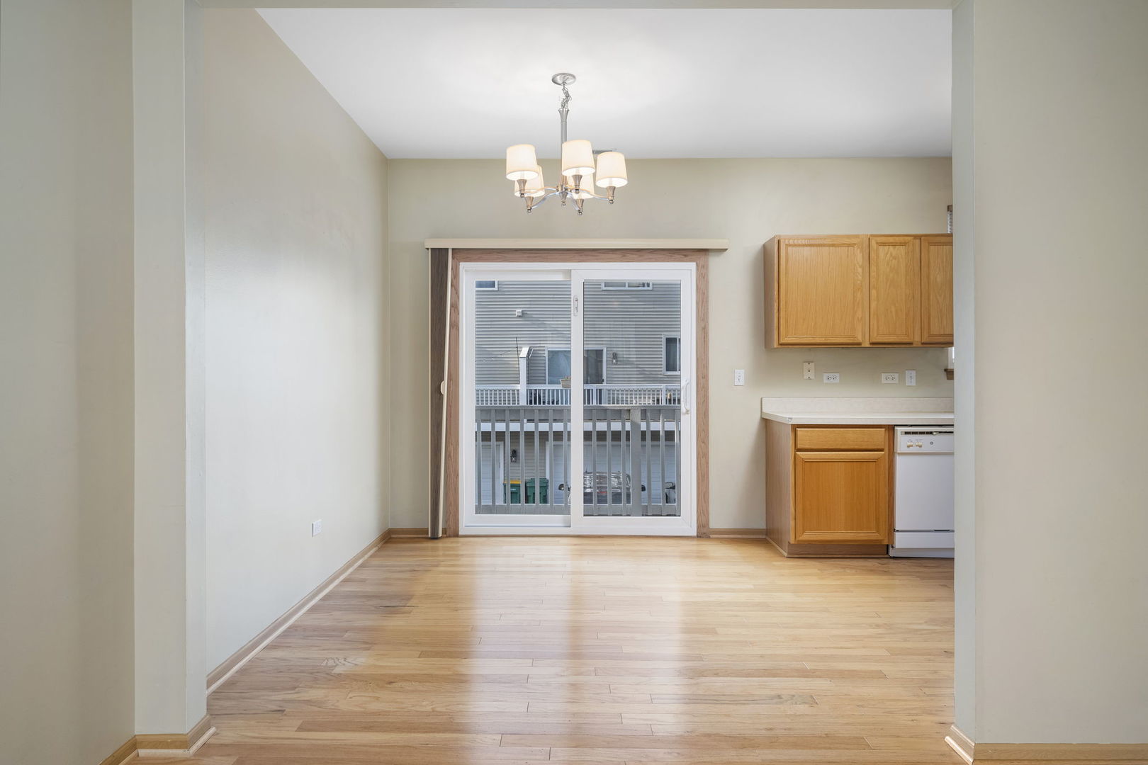 1784 Fieldstone Drive North Shorewood, IL 60404 - Photo 6 of 24 an empty room with a window and chandelier