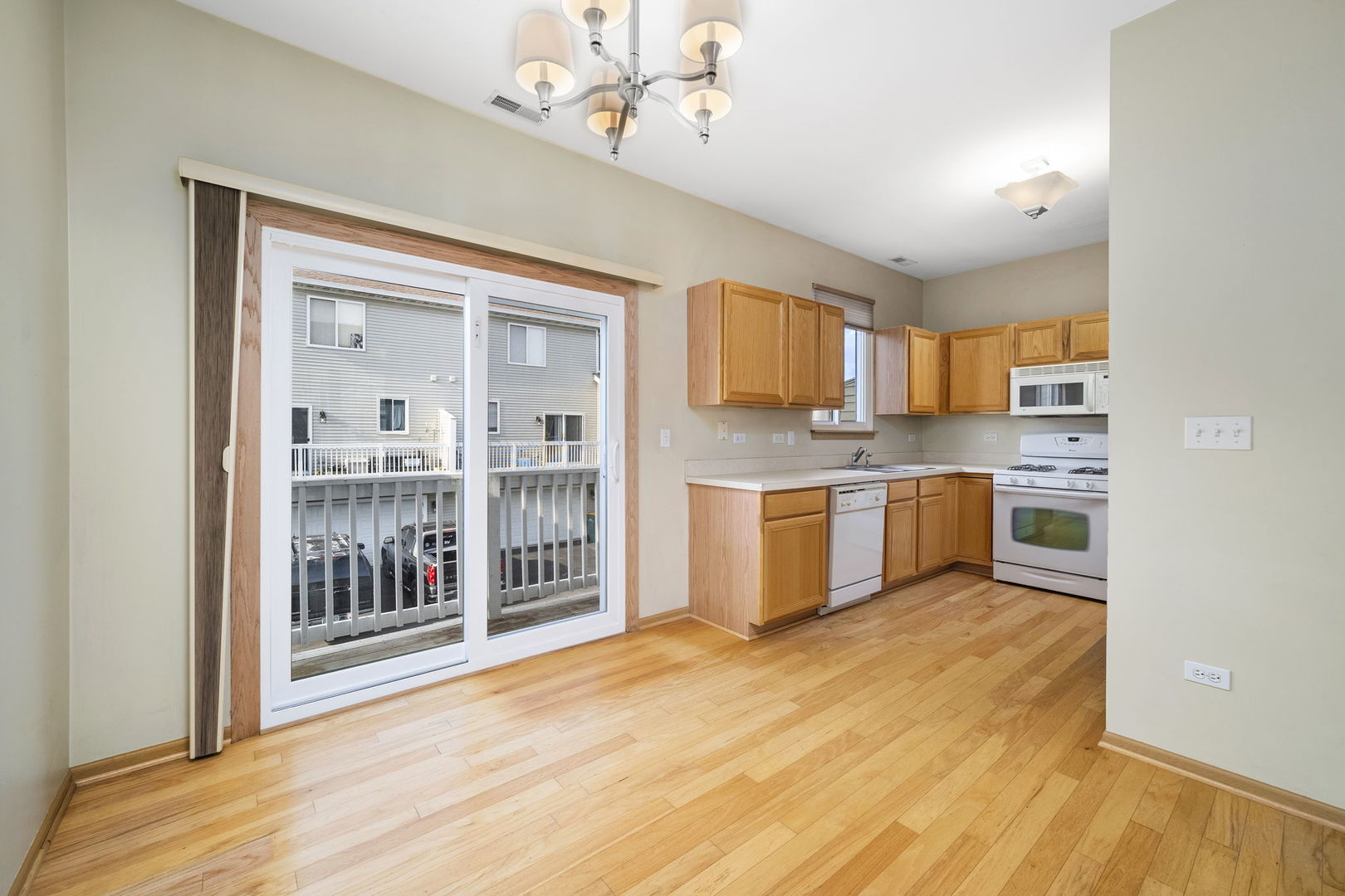 1784 Fieldstone Drive North Shorewood, IL 60404 - Photo 8 of 24 a kitchen with stainless steel appliances granite countertop a stove top oven a sink dishwasher and a refrigerator with wooden floor