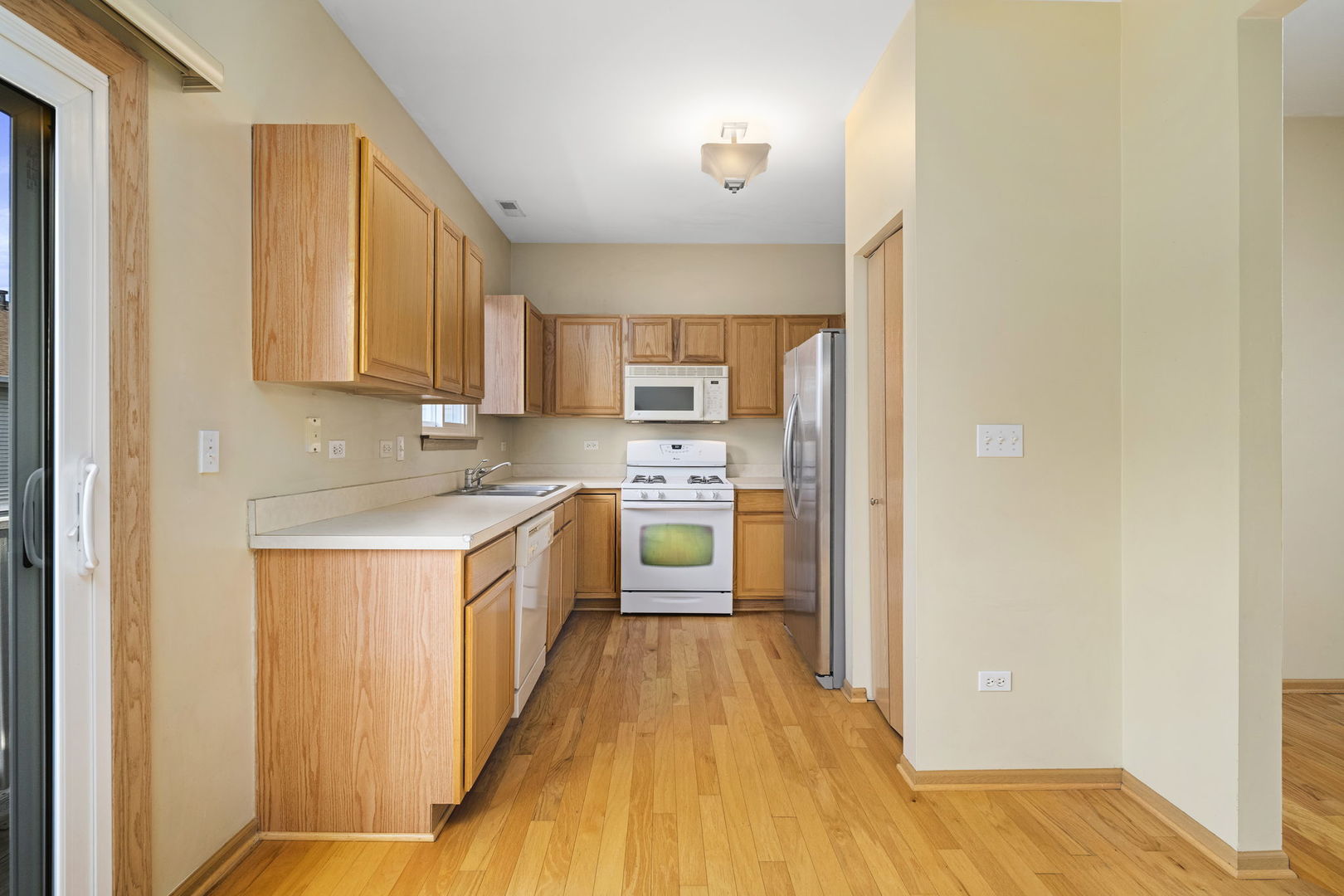 1784 Fieldstone Drive North Shorewood, IL 60404 - Photo 9 of 24 a large kitchen with stainless steel appliances granite countertop a stove a sink and a refrigerator