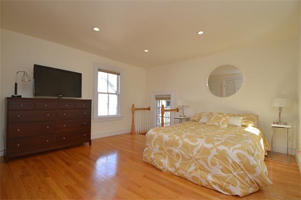 7 St Mary Road Cambridge, MA 02139 - Photo 16 of 24 a bedroom with a bed and a flat screen tv