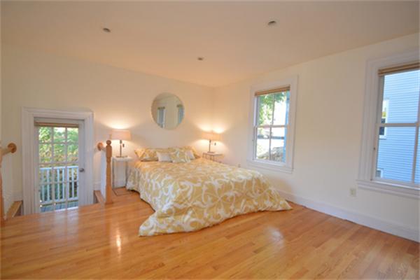 7 St Mary Road Cambridge, MA 02139 - Photo 17 of 24 a large bed sitting in a bedroom next to a window