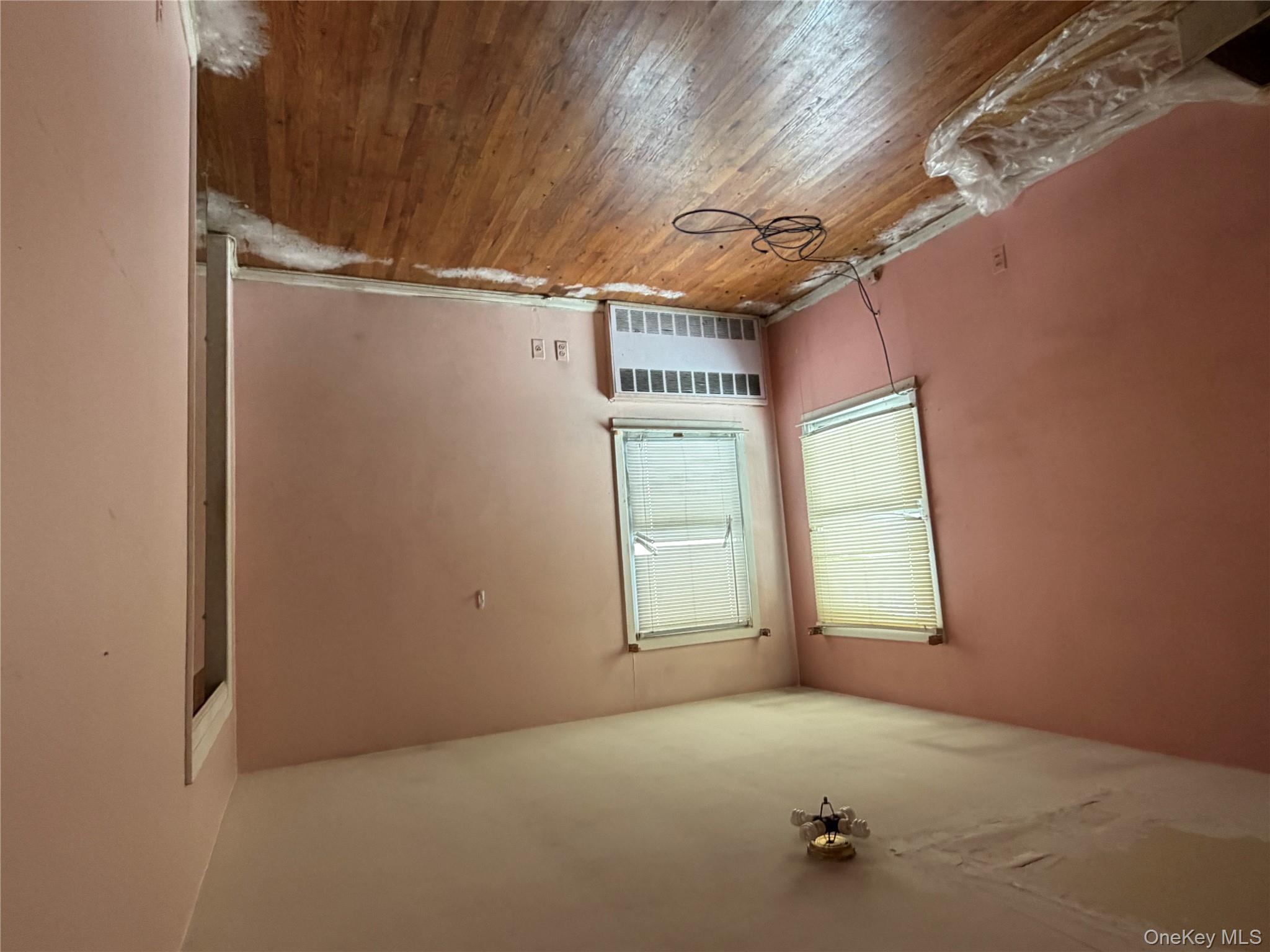 135-26 219th Street Queens, NY 11413 - Photo 11 of 43 an empty room with wooden floor and windows