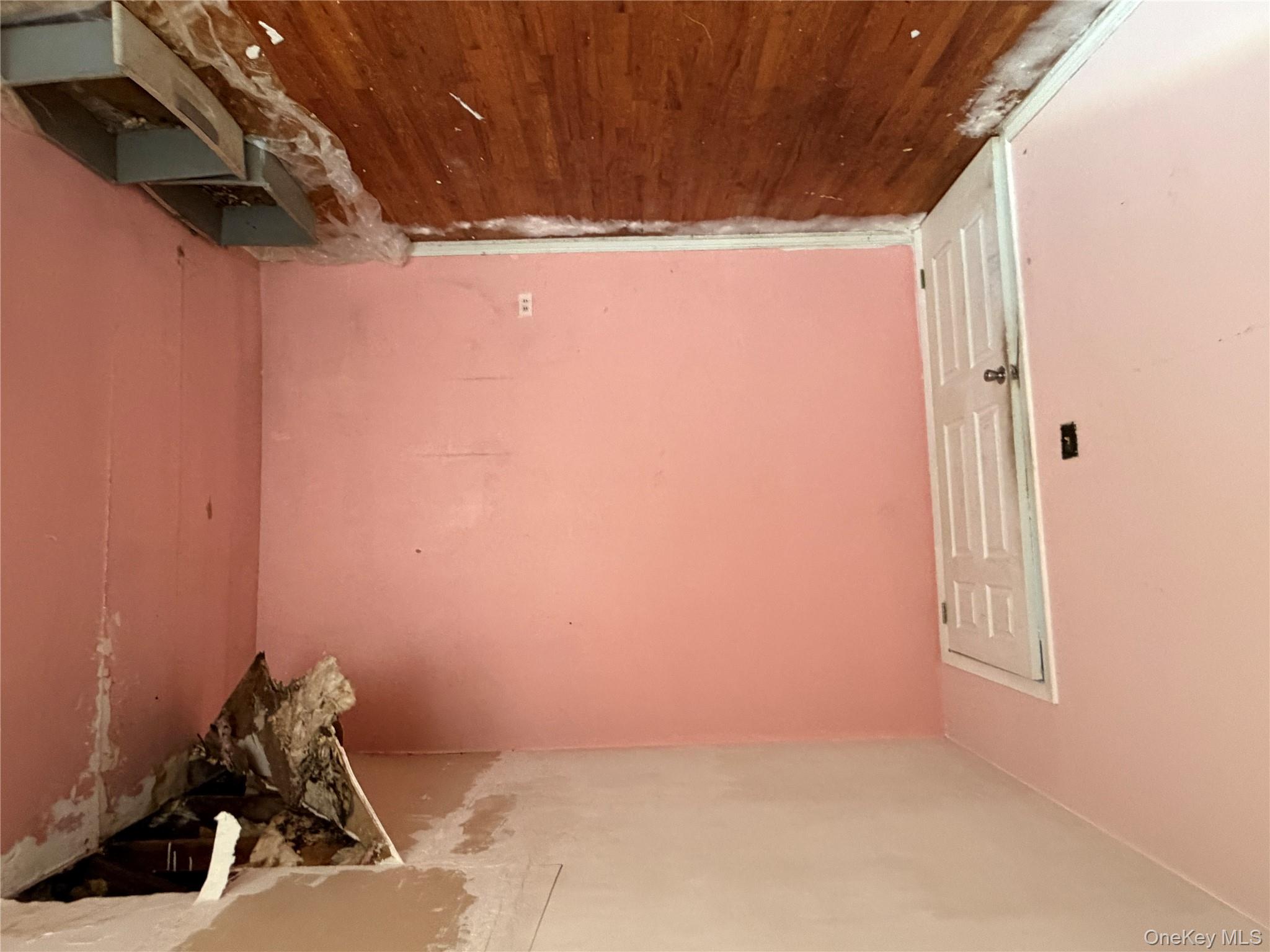 135-26 219th Street Queens, NY 11413 - Photo 12 of 43 a view of an empty room and wooden floor
