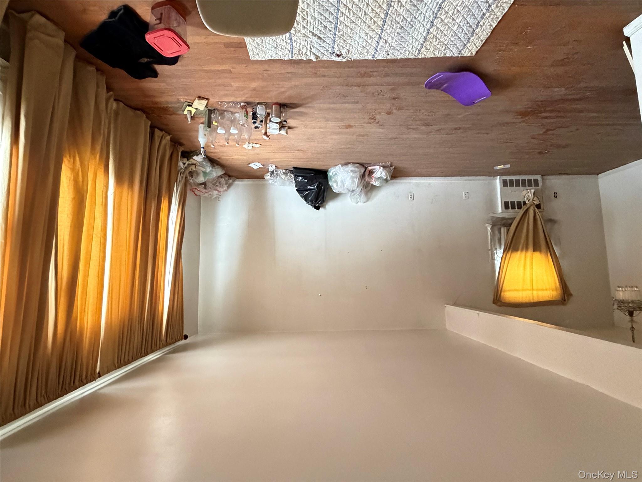 135-26 219th Street Queens, NY 11413 - Photo 15 of 43 a bedroom with a bed and a chandelier