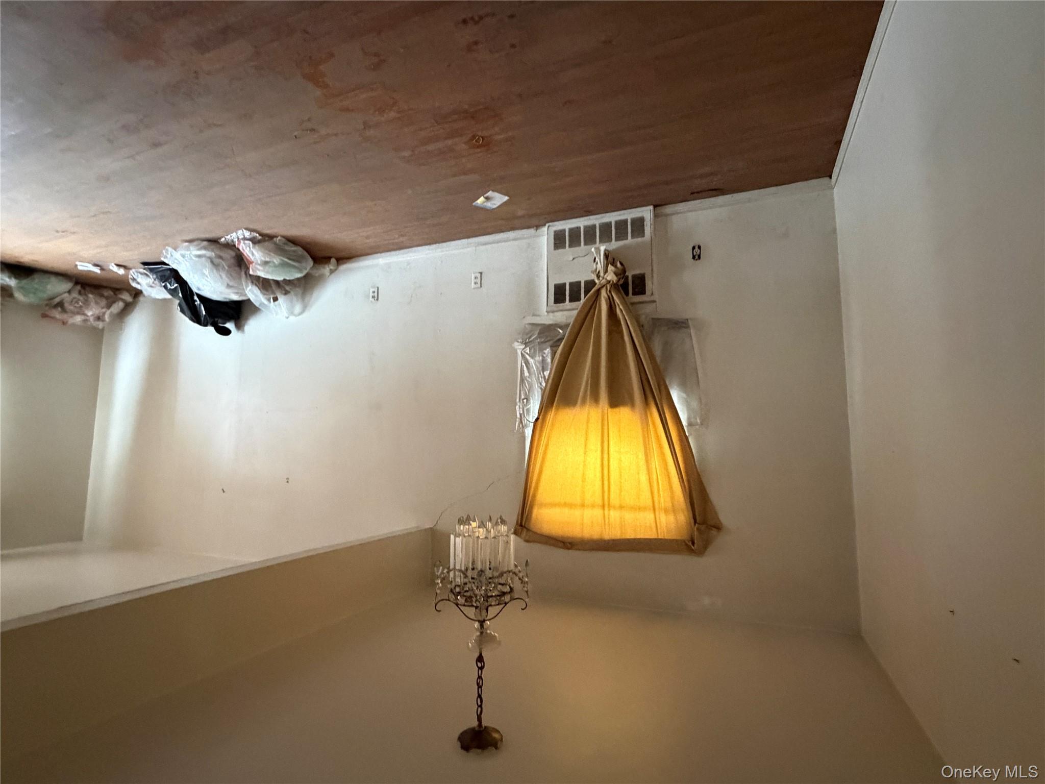 135-26 219th Street Queens, NY 11413 - Photo 20 of 43 a room with a window and chandelier