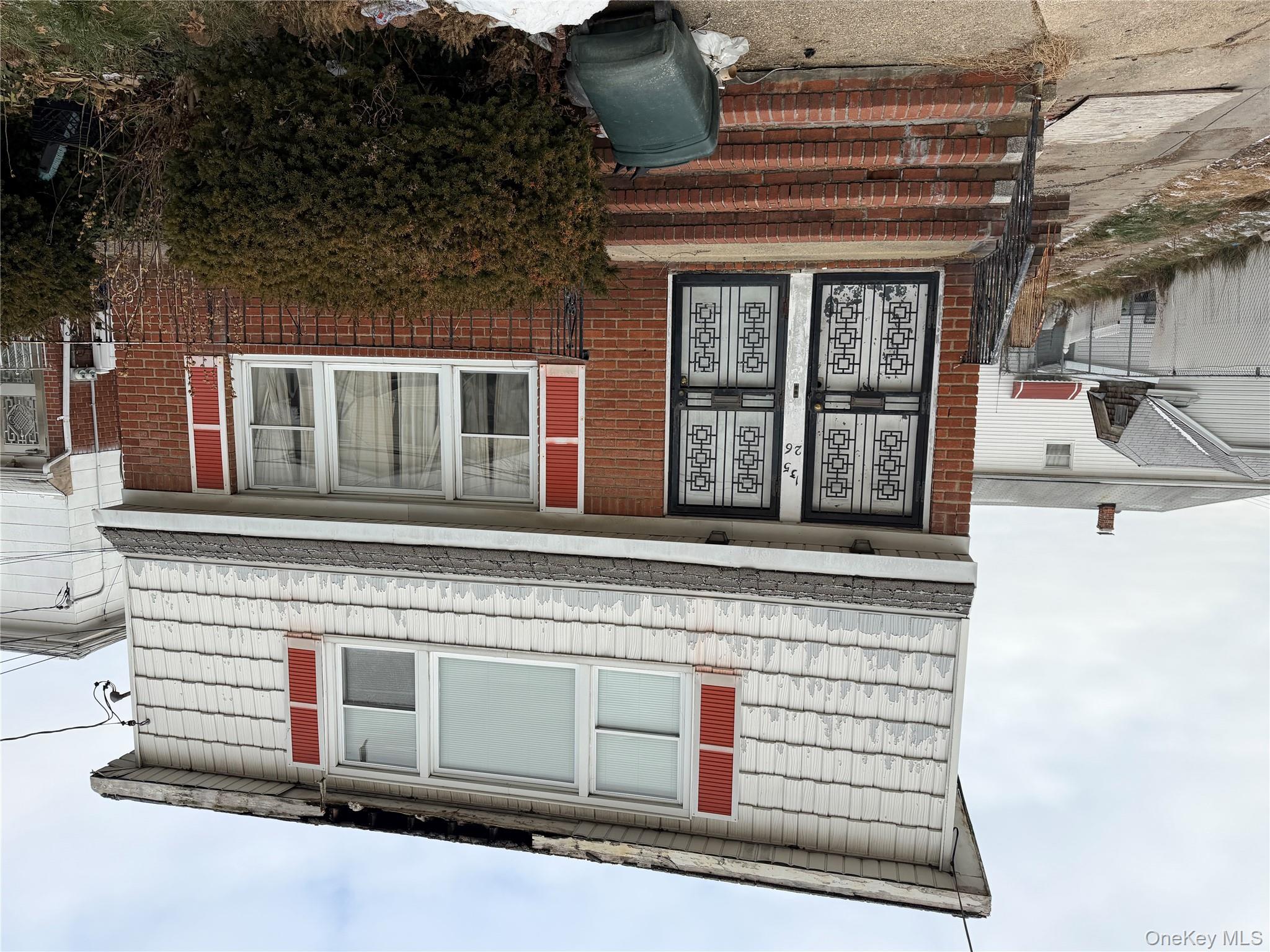 135-26 219th Street Queens, NY 11413 - Photo 2 of 43 a front view of a house with a yard