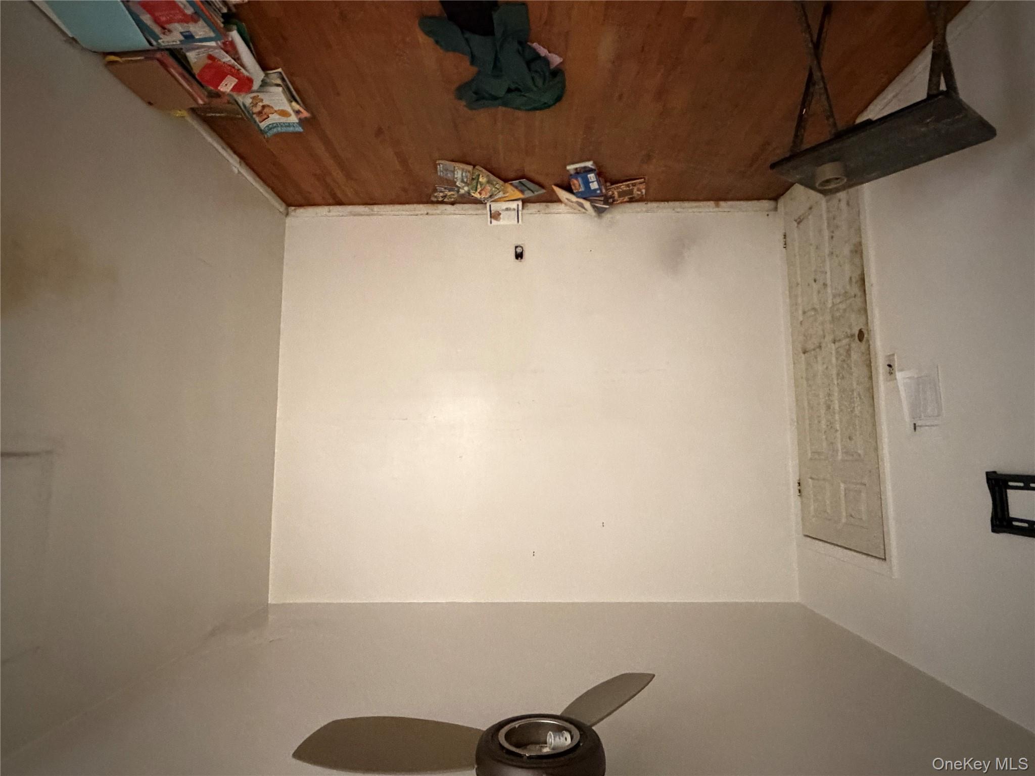 135-26 219th Street Queens, NY 11413 - Photo 35 of 43 a room with a bed and a chandelier fan