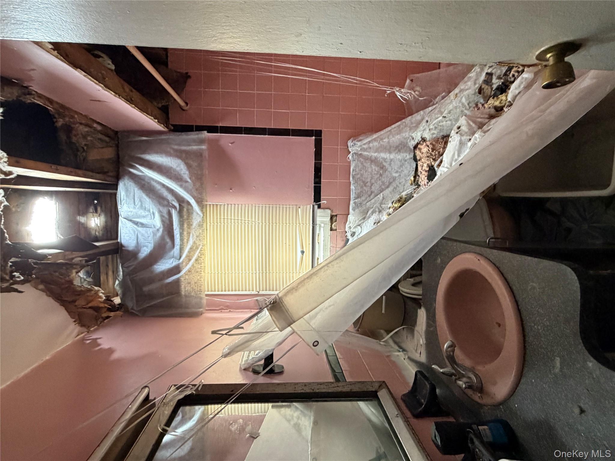 135-26 219th Street Queens, NY 11413 - Photo 41 of 43 a bathroom with a sink and a mirror