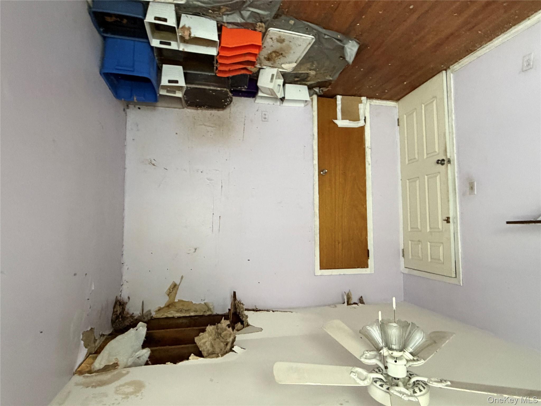 135-26 219th Street Queens, NY 11413 - Photo 9 of 43 a bedroom with a bed and a chandelier fan