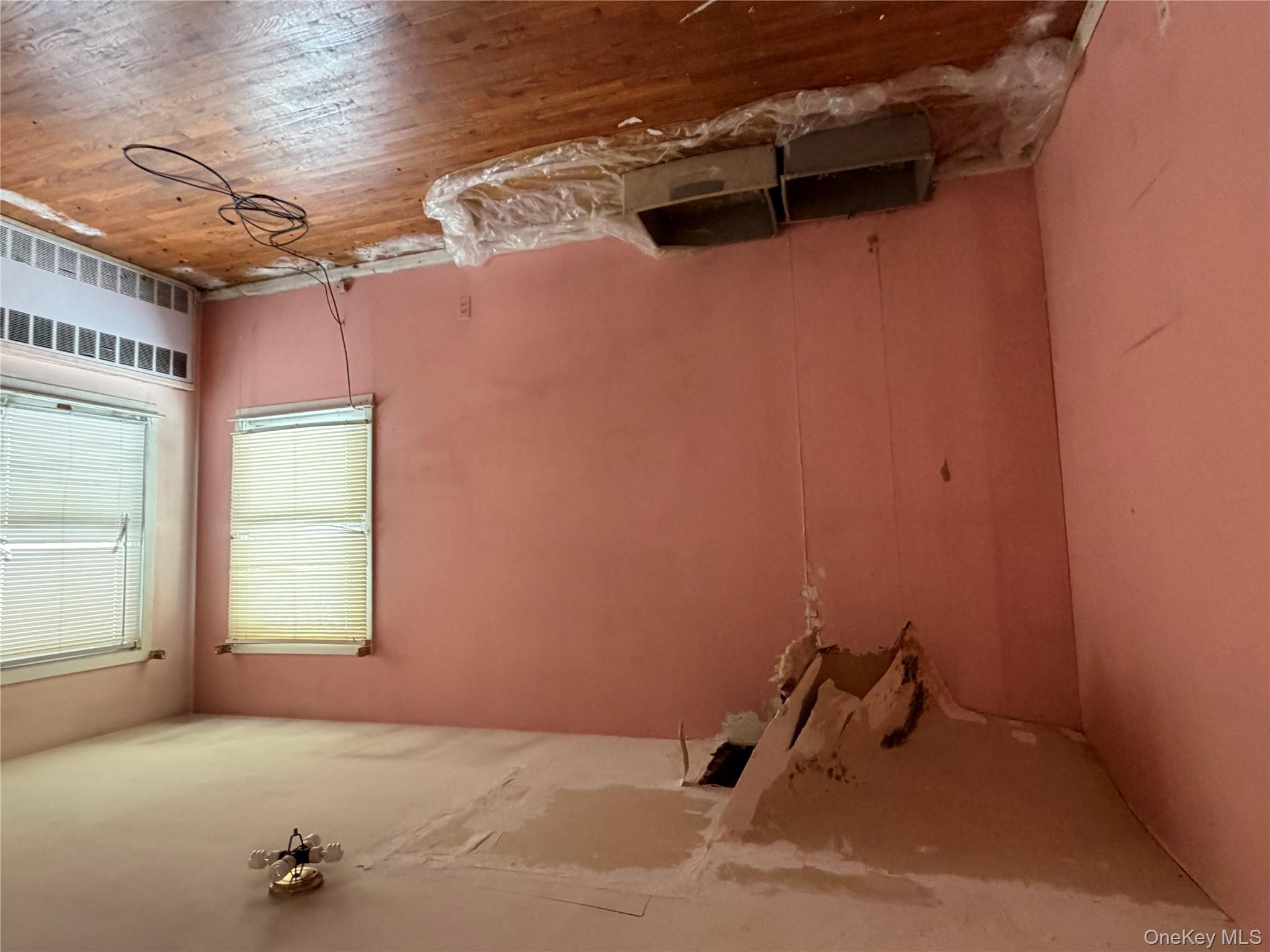 135-26 219th Street Queens, NY 11413 - Photo 10 of 43 a bedroom with a bed and a window