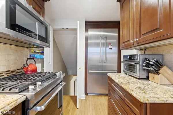 a kitchen with stainless steel appliances granite countertop a stove and a refrigerator