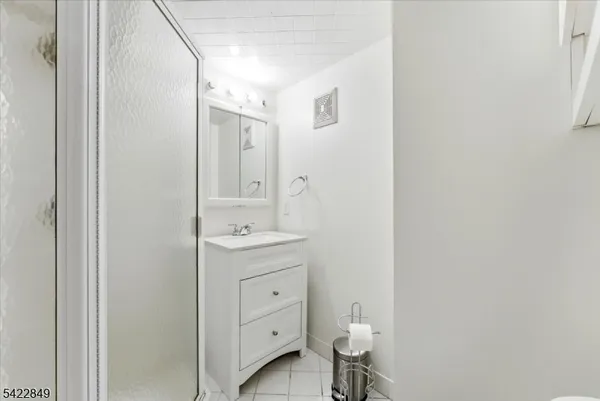 a bathroom with a granite countertop sink toilet and a mirror