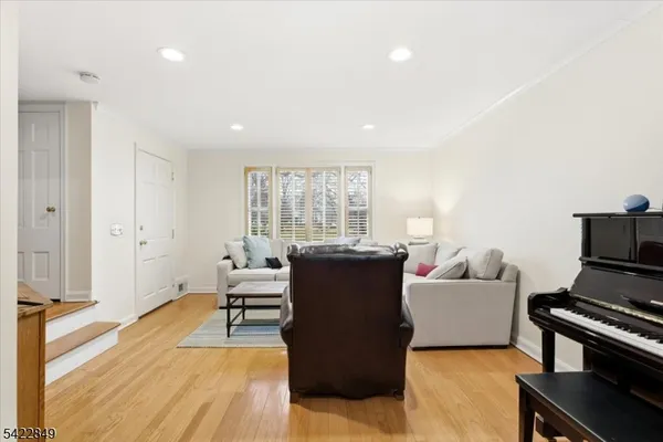 a living room with furniture and a open kitchen view