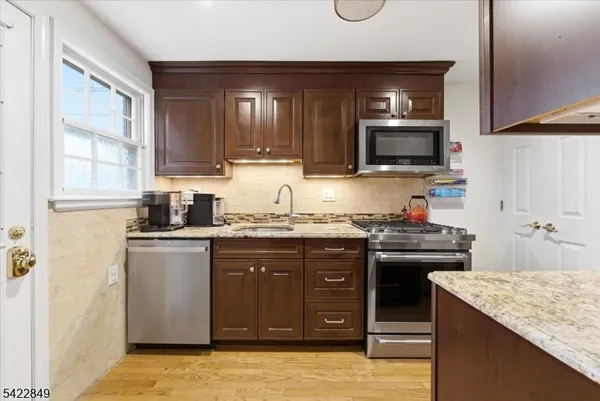 a kitchen with granite countertop a sink and cabinets