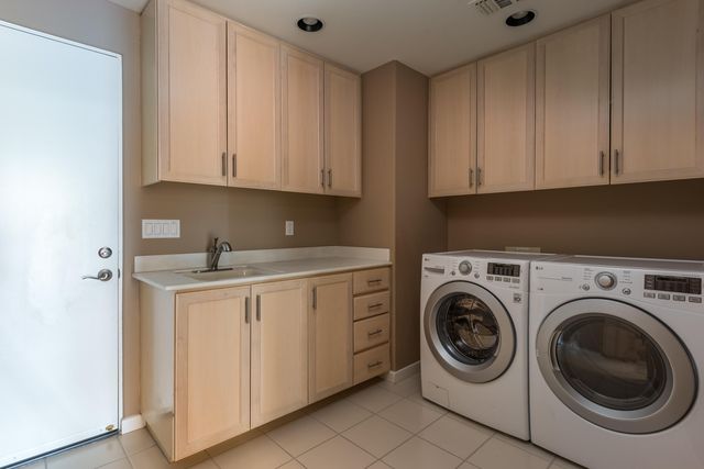 a utility room with sink dryer and washer