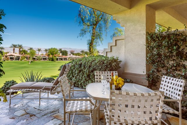 a view of a chairs and table in patio