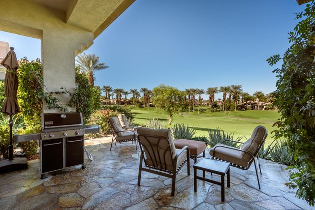 a view of a chairs and table in patio