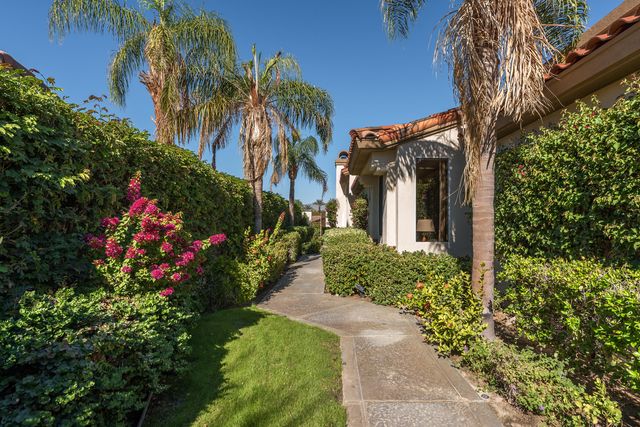 a view of a house with a lot of flower plants