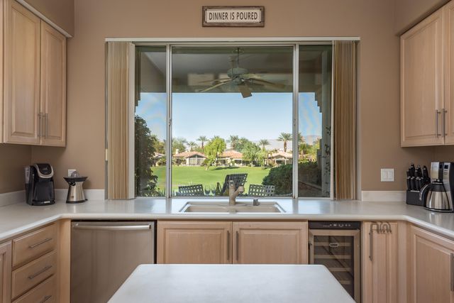 a kitchen with stainless steel appliances kitchen island granite countertop a sink and cabinets