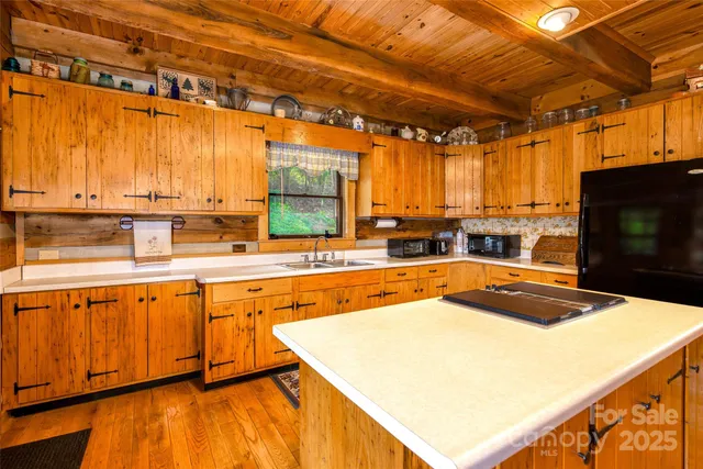 a kitchen with stainless steel appliances a stove a sink and a microwave