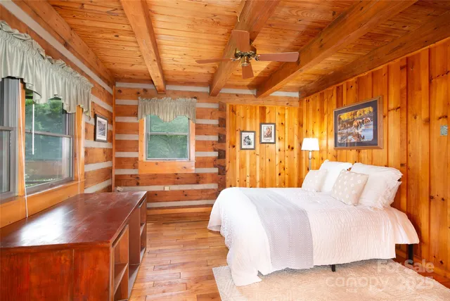 a spacious bedroom with a large bed and a large window