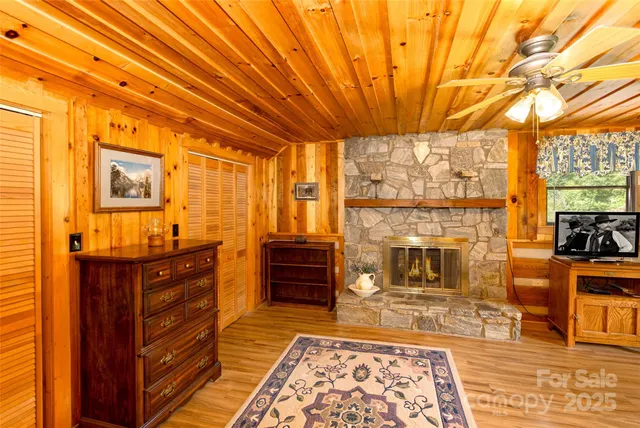 a spacious bedroom with a bed and wooden floor