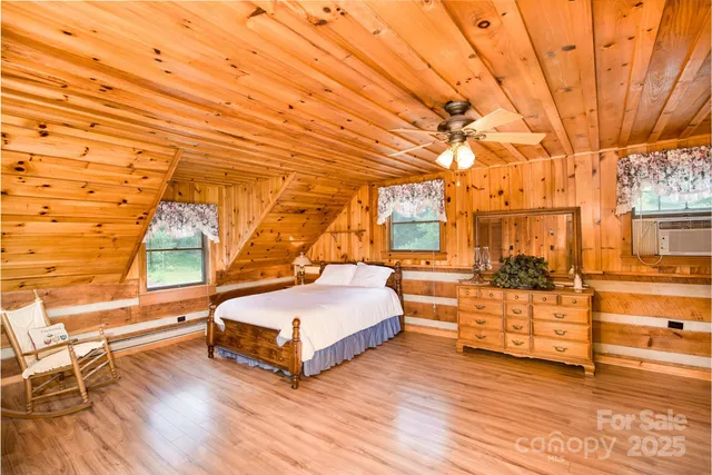 a spacious bedroom with a bed and a window