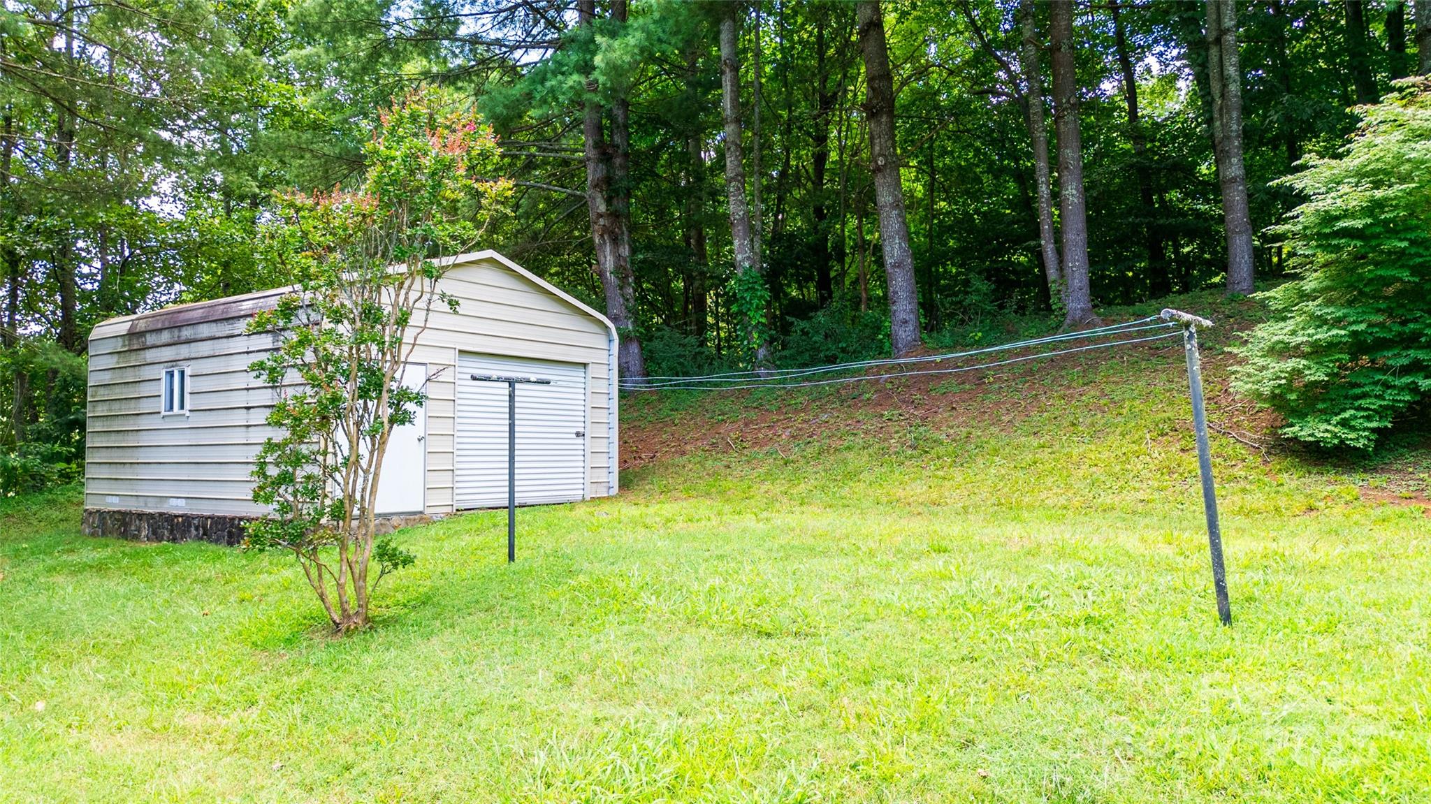 83 Daybreak Ridge Sylva, NC 28779 - Photo 29 of 40 a view of a backyard with a small cabin